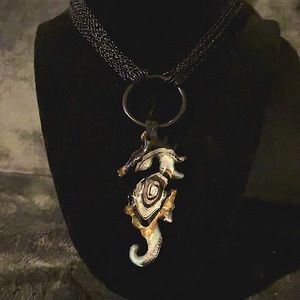 Glass seahorse necklace.